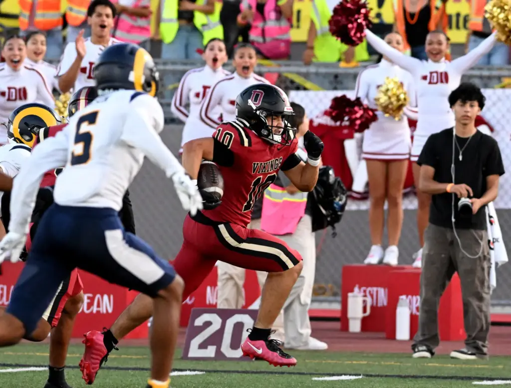 Downey’s Jayden Diaz (10) runs for a touchdown in the...