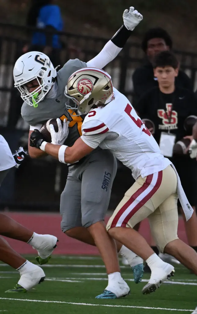 Crean Lutheran Troy Roberts (4) runs the ball for a...
