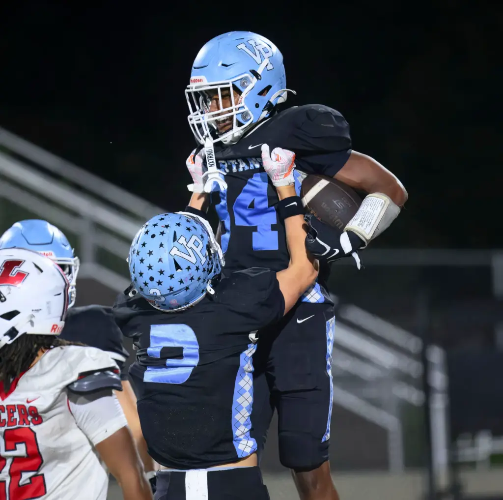 Villa Park running back Coy Collins, right, celebrates after scoring...