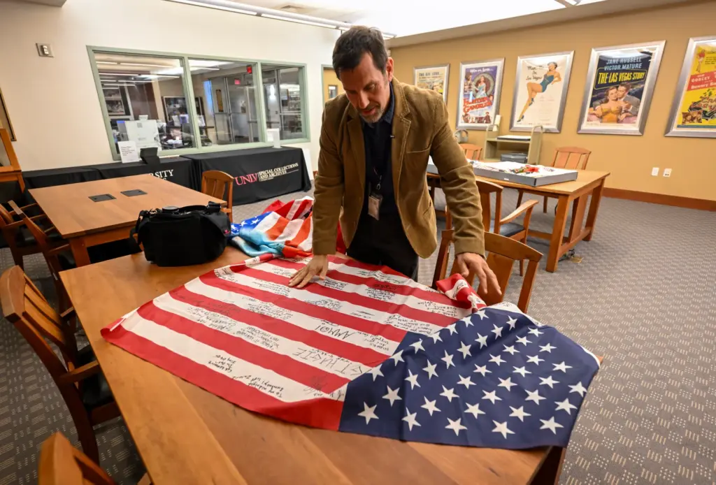 Professor David G. Schwartz looks over artifacts that were part...