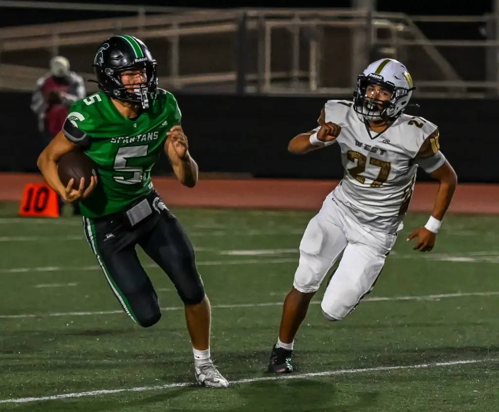South Torrance quarterback Jake Egan runs with the ball during...