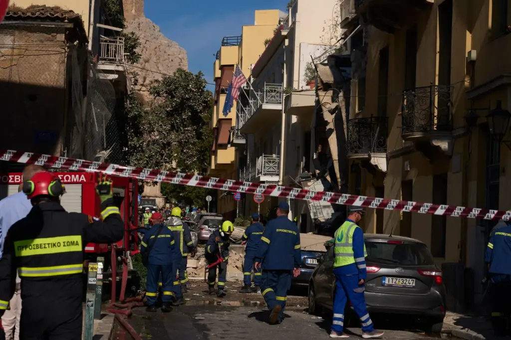 Firefighters work at the scene following a powerful blast that...