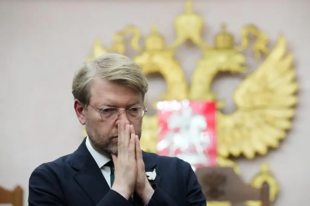 FILE – Yabloko party leader Nikolai Rybakov stands at a...