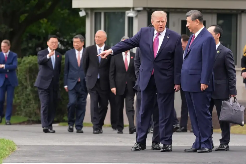 President Donald Trump, left, speaks with China’s President Xi Jinping...