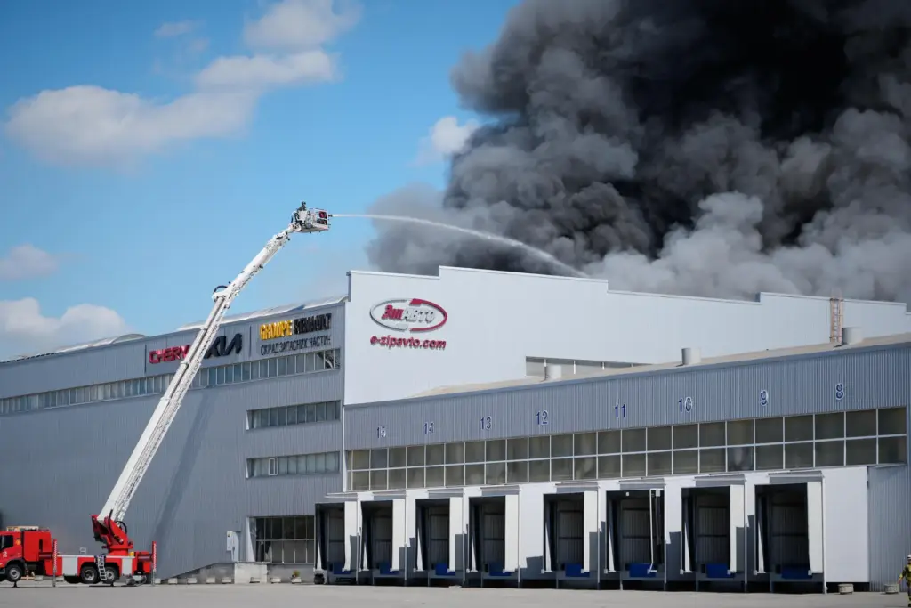 Firefighters put out a fire at warehouse stores after a...