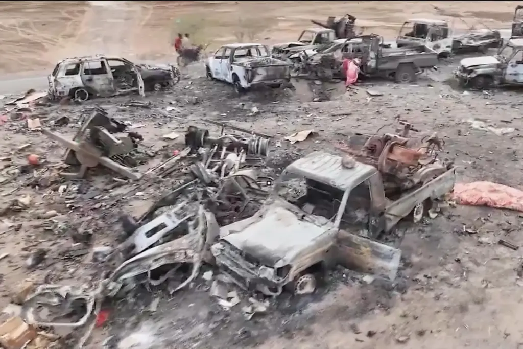 Damaged vehicles on a road between the Dhubab and Amri junctions in Yemen