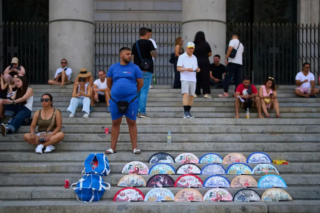 A street vendor sells fans near the Royal Palace in Madrid.