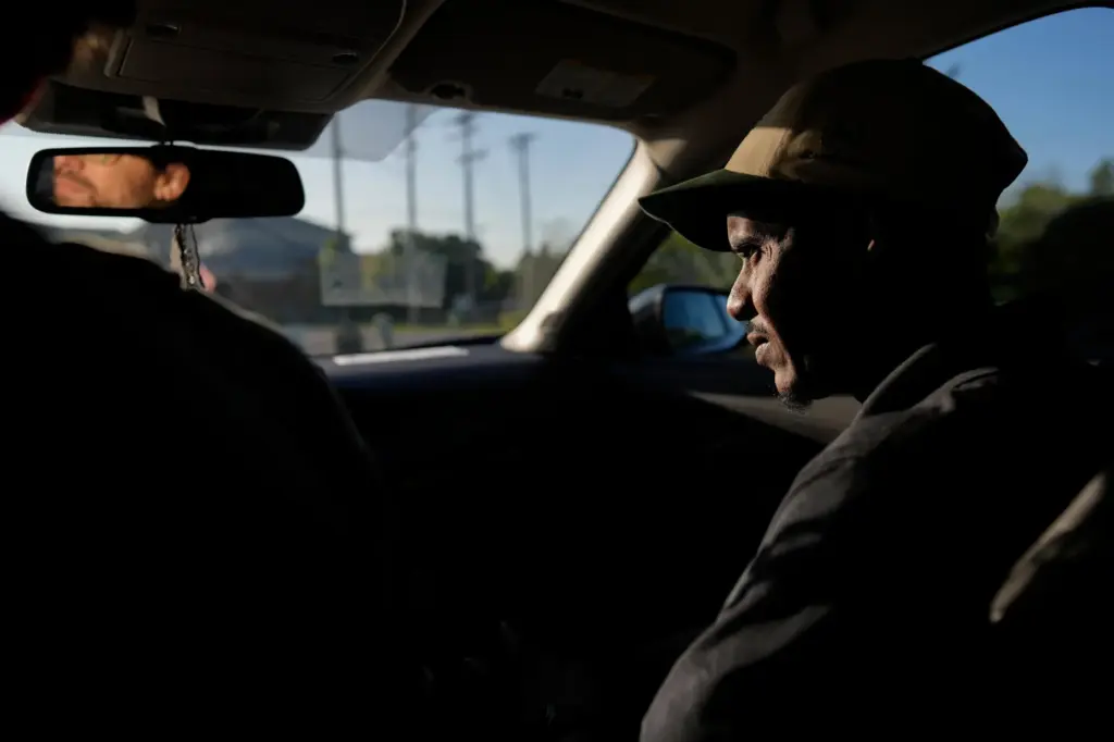 Samba Diallo, right, a Mauritanian immigrant, is driven by Vincent...