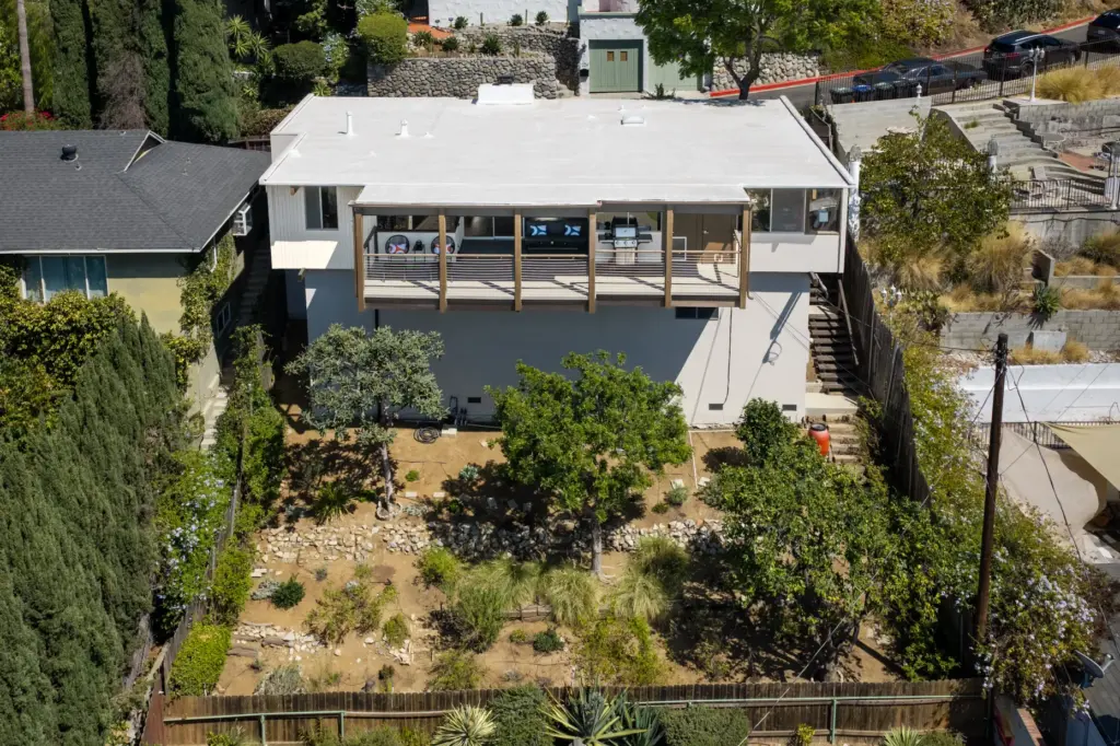 The house sits high on a downslope lot in the...