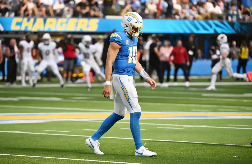 Chargers quarterback Justin Herbert (10) walks off the field after...