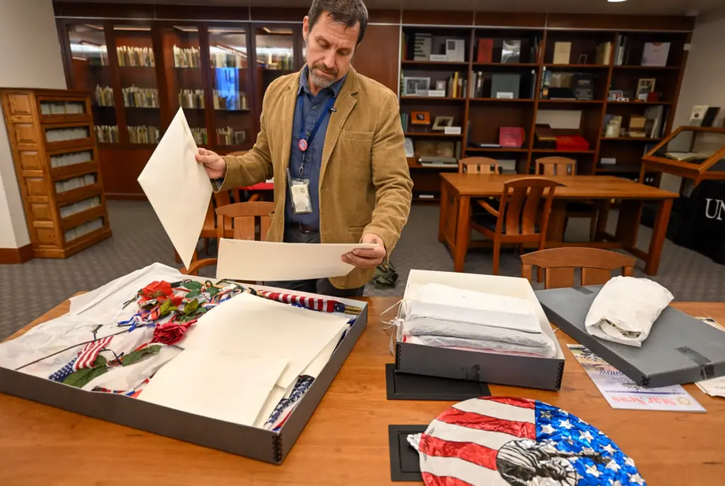 Professor David G. Schwartz looks over artifacts that were part...