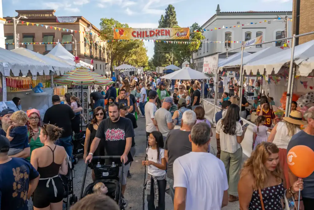 Families visit game booths on the Children Street, new this...