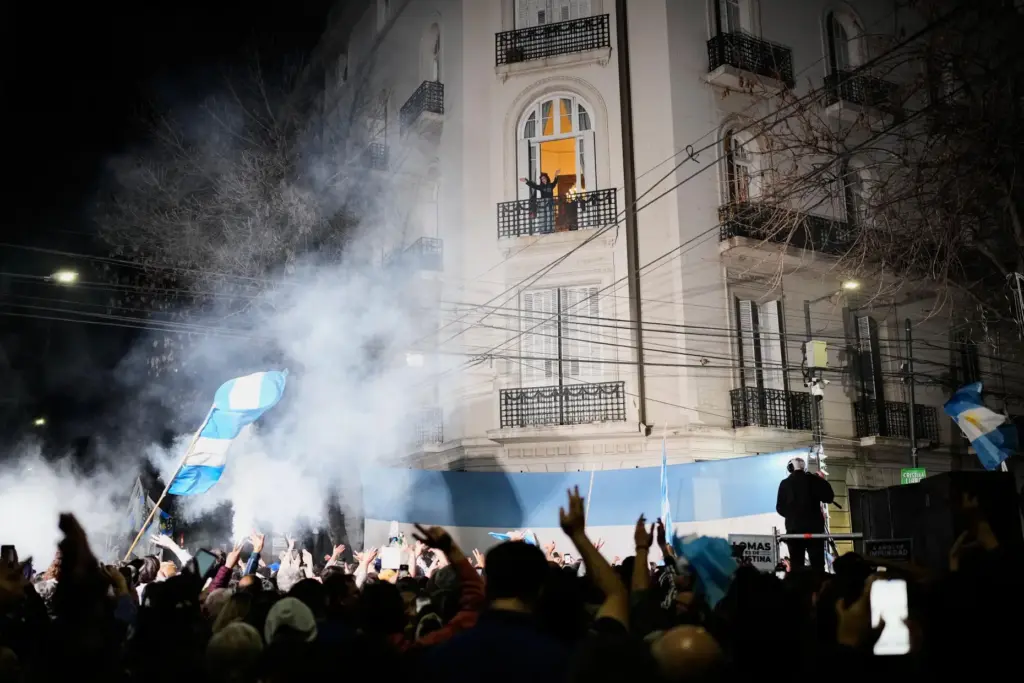 Former Argentine President Cristina Fernandez waves from the balcony of her home.