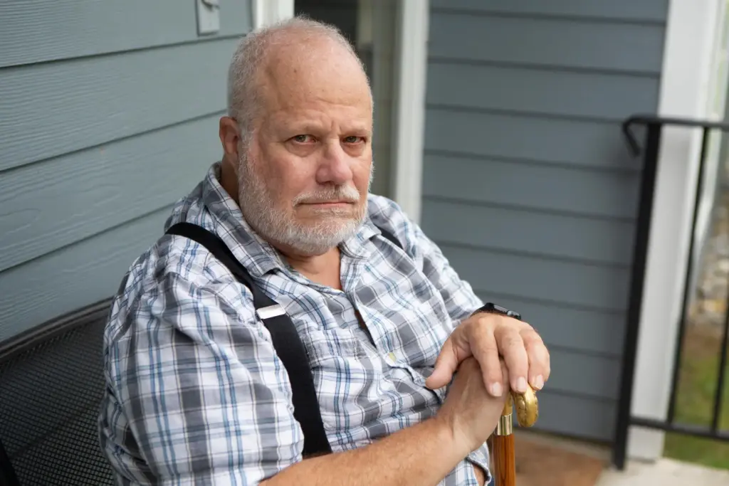 Jeff La Marca sits on a porch.