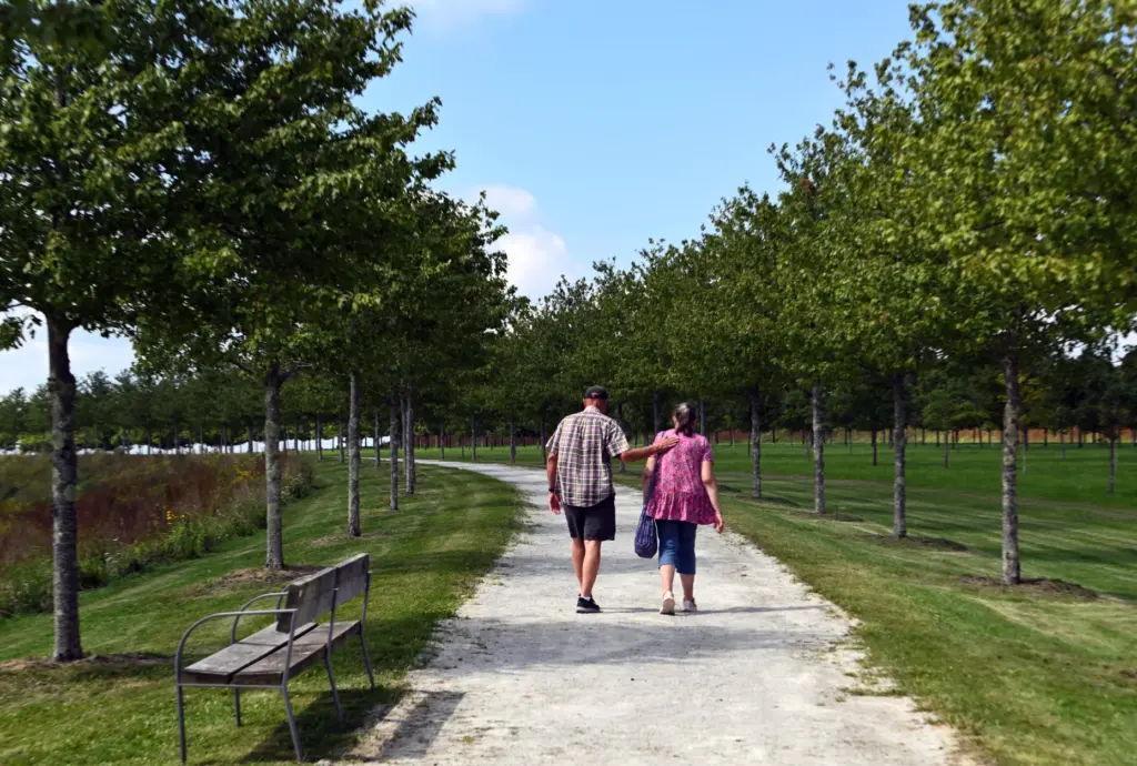 Hal Mante, and his wife, Joyce Mante, walk along a...