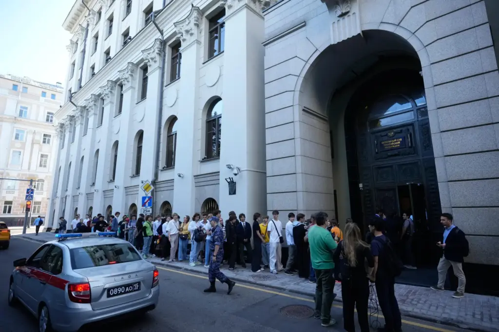 Supporters of the Yabloko party wait to enter Russia's Supreme Court.