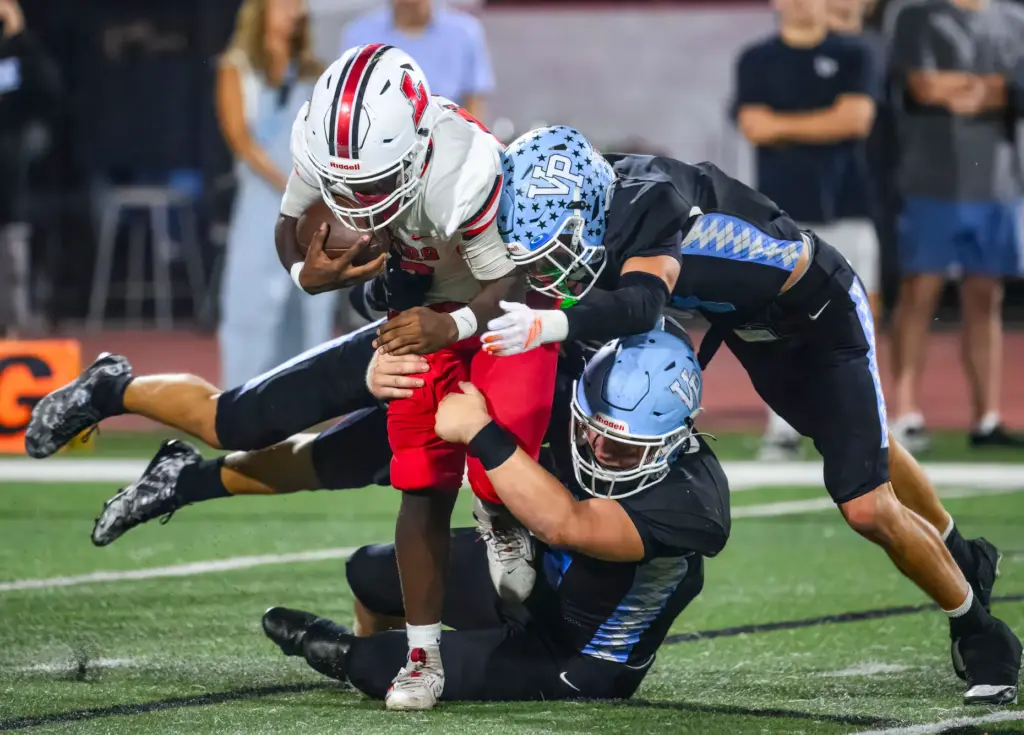 Lakewood defensive back Jacob Carey is brought down by Villa...