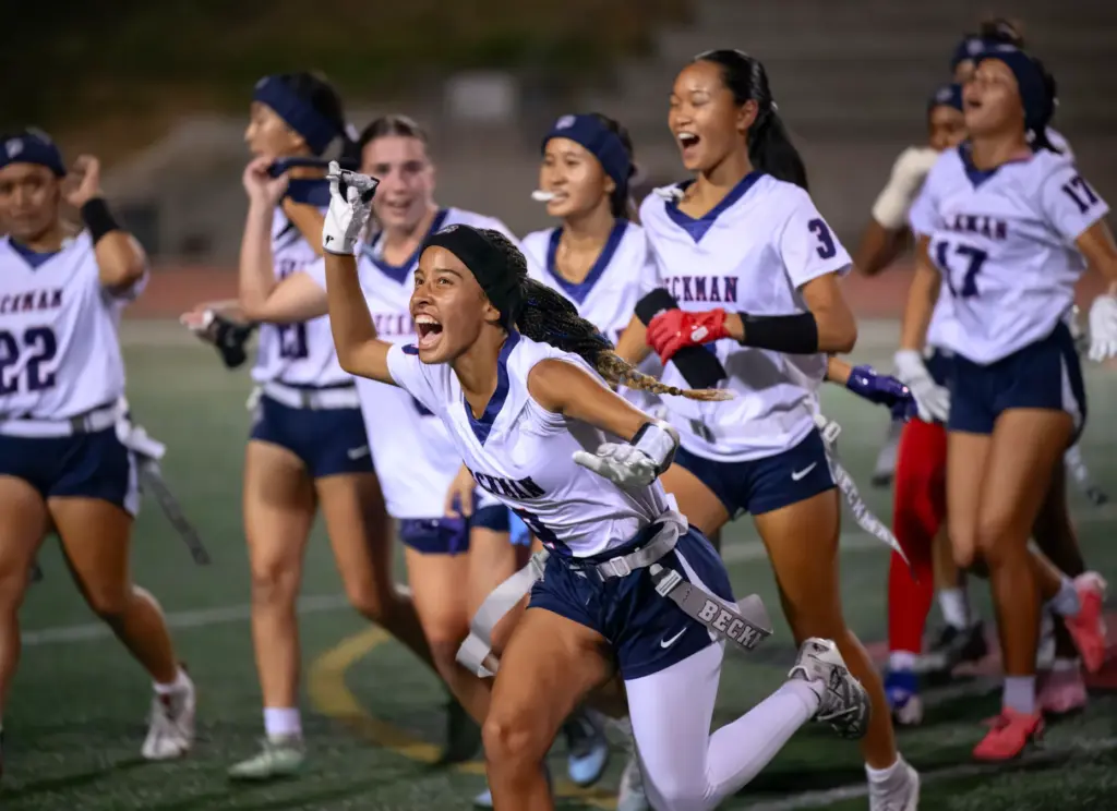 Wide receiver Kalaya Long, center, celebrates Beckmanâs flag football win...