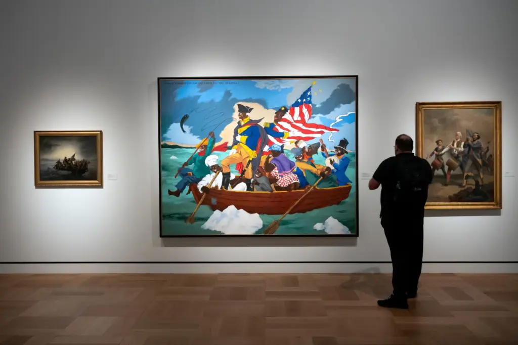 Visitors view a work by Robert Colescott at the Lucas...