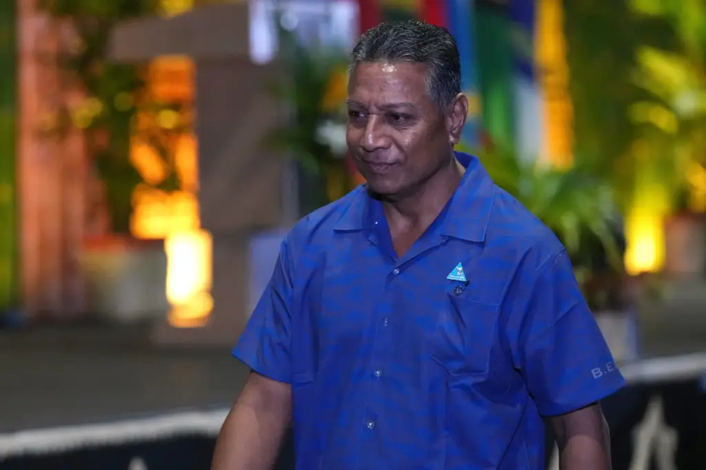 Kiribati's director of foreign service and former ambassador to China, David Teaabo, walks to his seat.