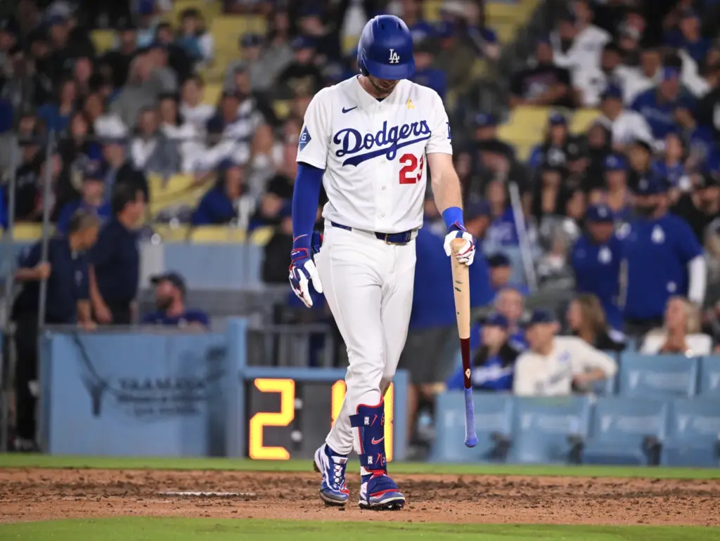 Dodgers right fielder Kyle Tucker walks toward the dugout after...