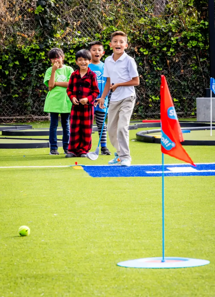 Mario Martinez, 8, practices his golf skills after school at...