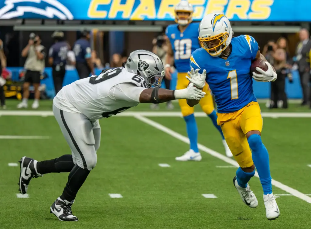 Chargers wide receiver Quentin Johnston (1) carries the ball during...