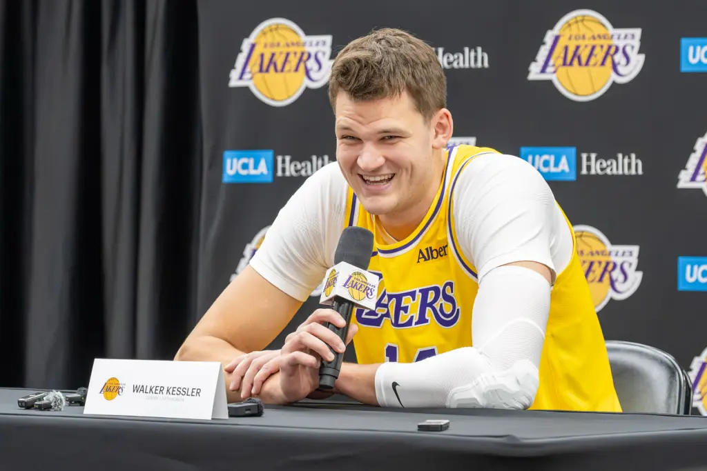 New Lakers center Walker Kessler listens to questions from reporters...