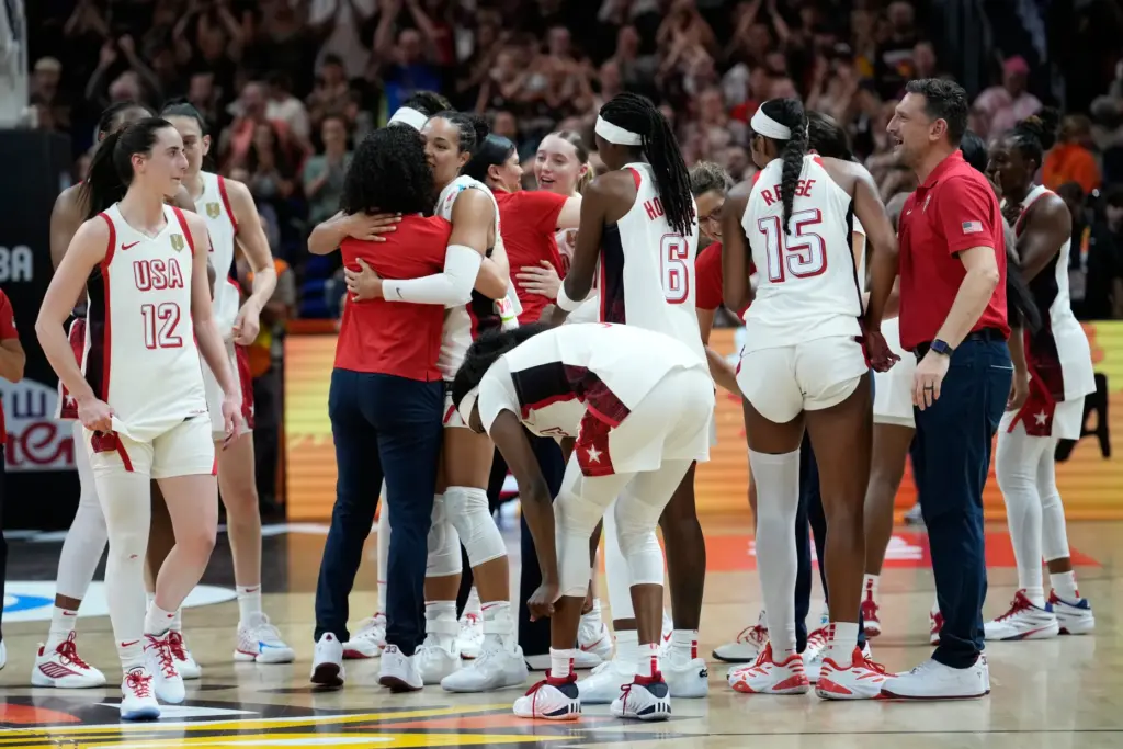 Team USA players and coaches celebrate after defeating France in...