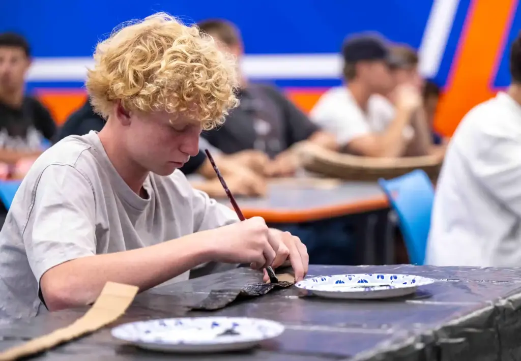 Billy Williams, a freshman at Los Alamitos High School, paints...