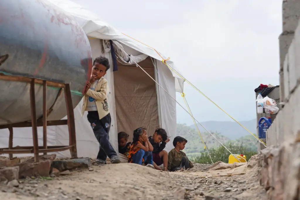 Displaced Yemeni children from Al-Kadha, west of Taiz, gather at the Al-Akdaf camp.