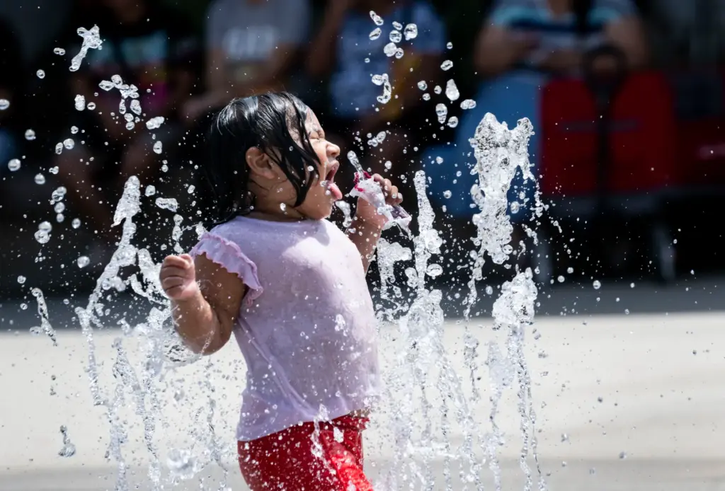 Two-year-old Nidia Mirella plays in the fountain at Miraloma Park...