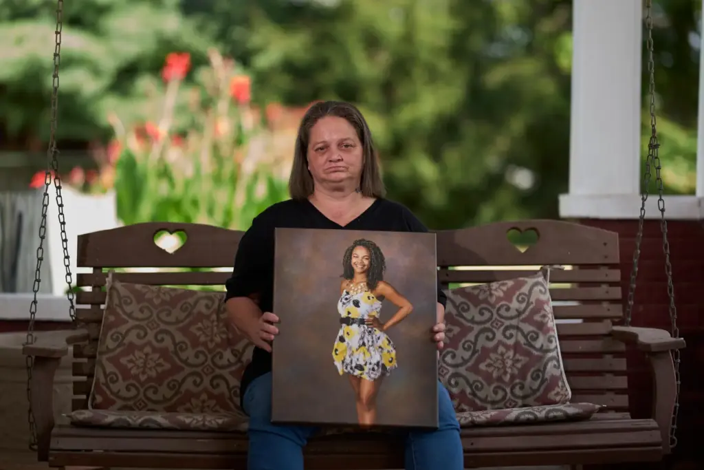 Christy Spivey poses with a portrait of her late daughter,...