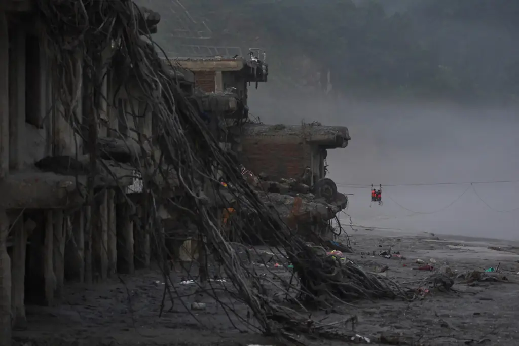 Residents commute across the Trishuli river on a newly installed...