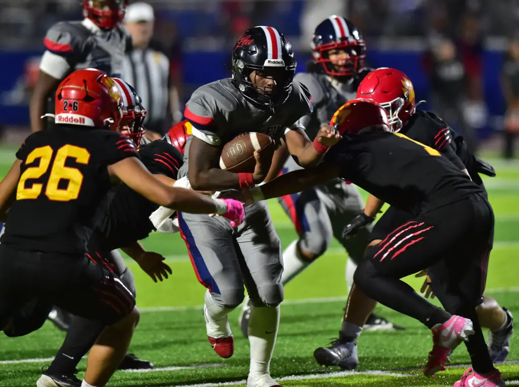 Leuzinger back Milton Jefferson cuts thru Hawthorne defense in the...