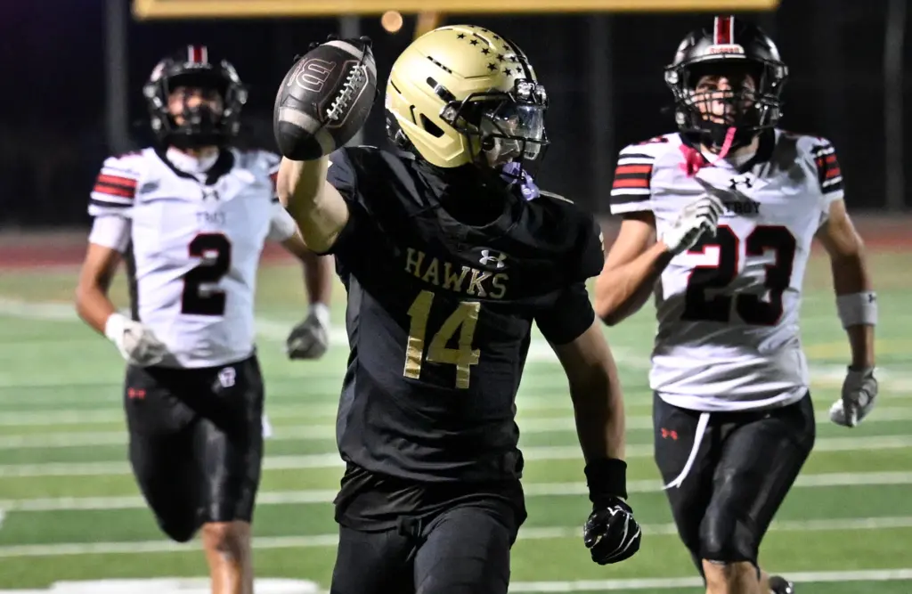 Mason Shackleton #14 of El Dorado runs for a touchdown...