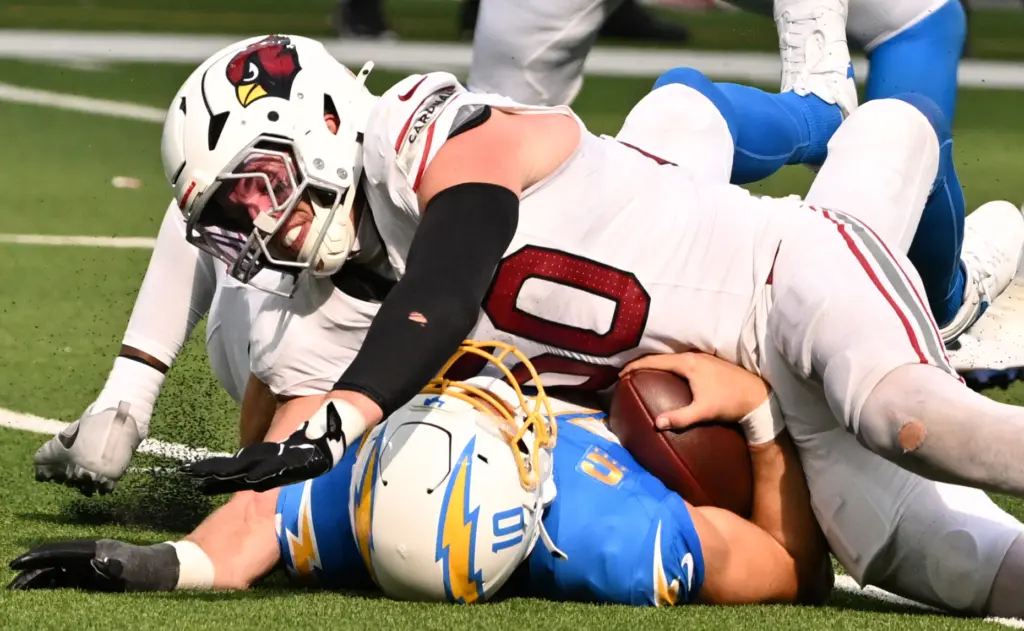 Chargers quarterback Justin Herbert (10) is sacked by Arizona Cardinals...