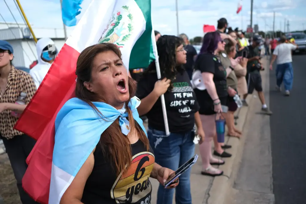 People protest where local authorities say a U.S. Immigration and...