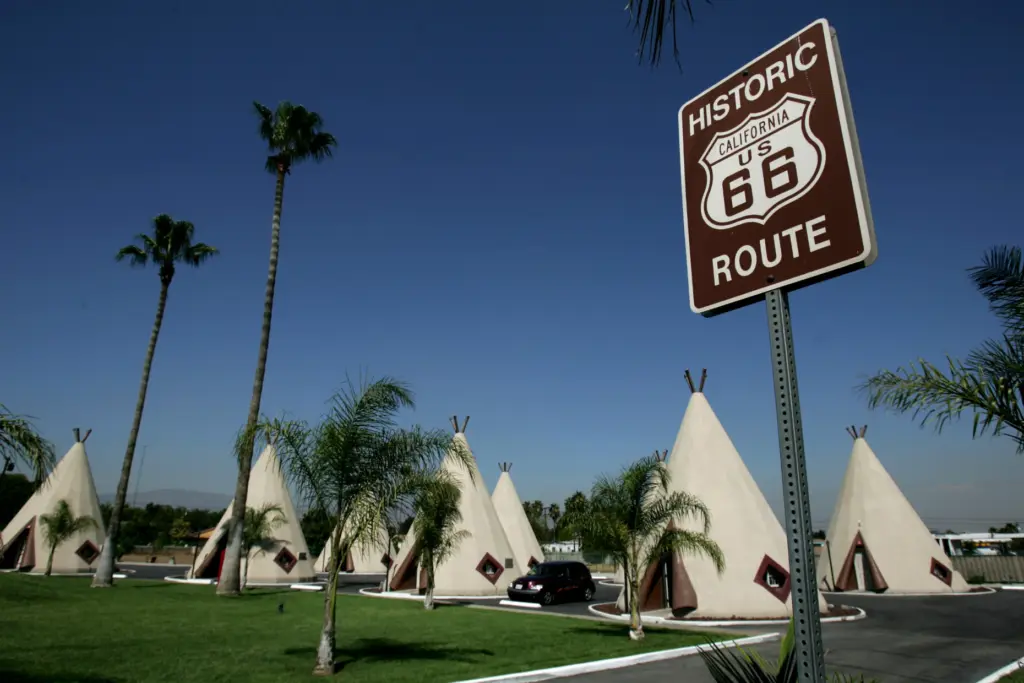 Motel rooms shaped like teepees sit in the background at...