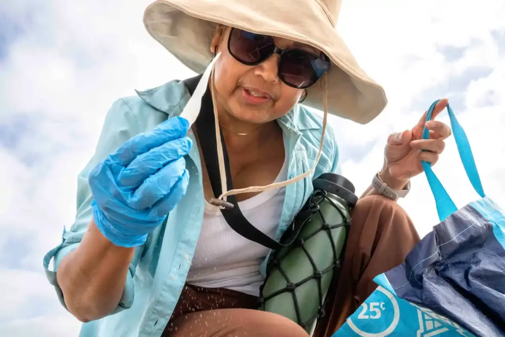 Flor Hotchkiss looks at a piece of plastic she pulled...