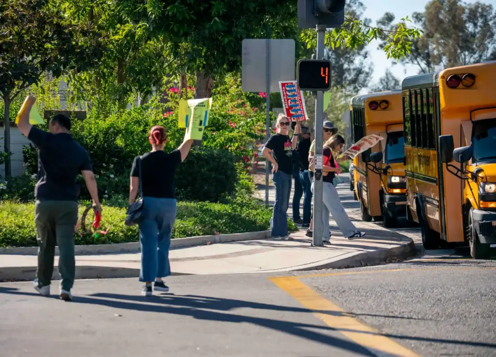 Members and supporters of the Saddleback Valley Educators Association cross...
