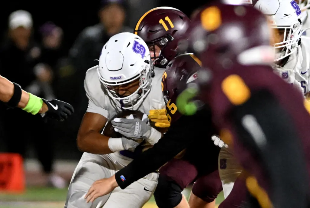 St. Anthony Saints Evan Martinez (3) is tackled as he...