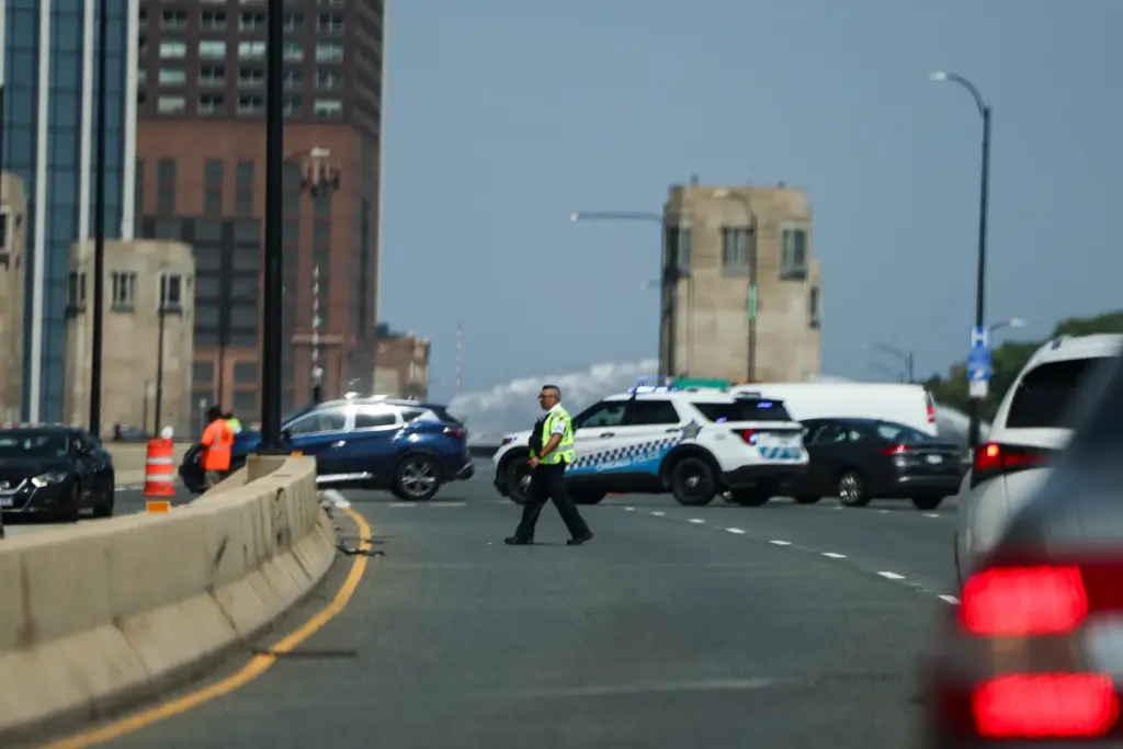 Officials direct motorists to an alternate route as the stuck...