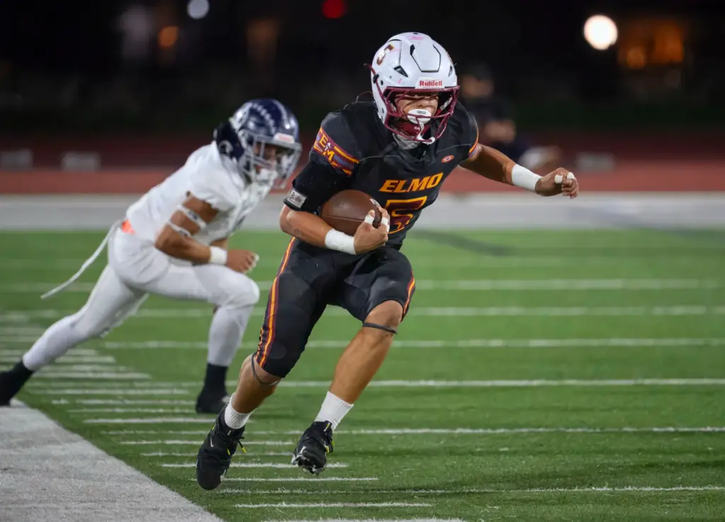 El Modena’s Hayden Esparza gains yardage as he runs down...