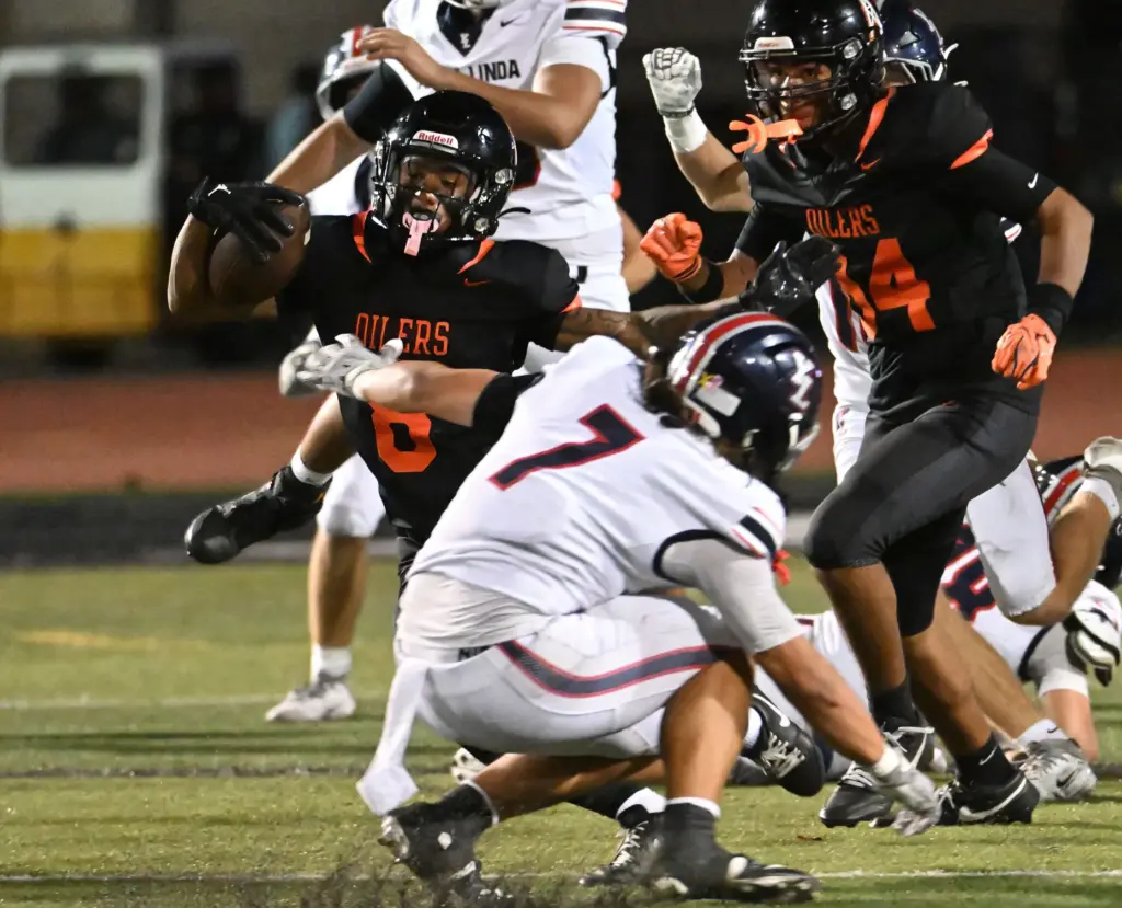 Huntington Beachâs Skylar Robinson (8) takes the ball past Isaiah...