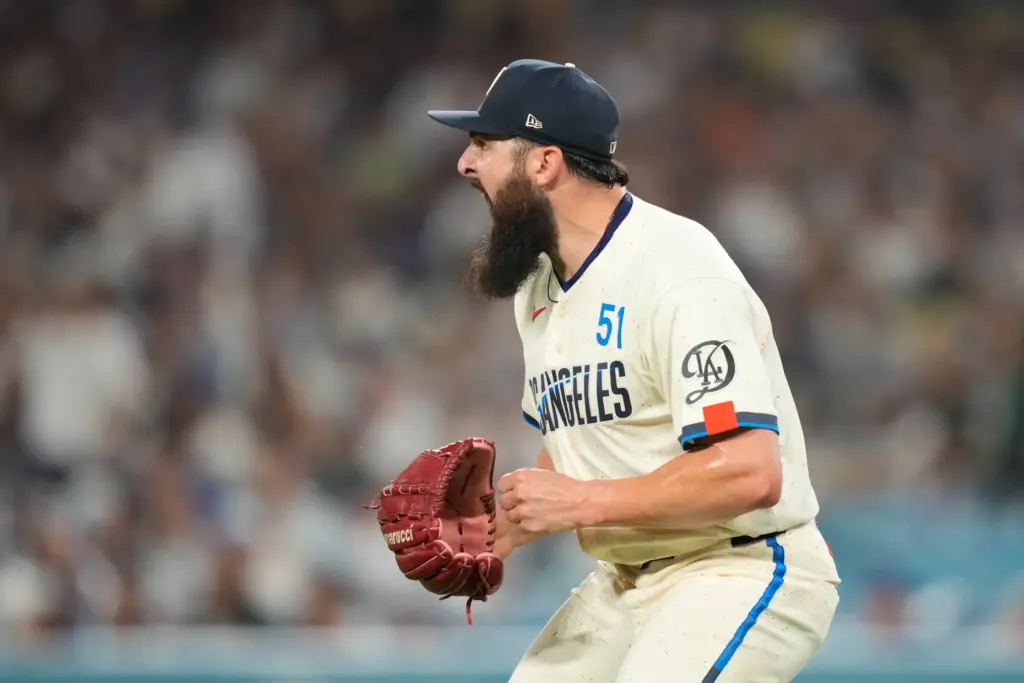 Dodgers pitcher Alex Vesia celebrates as a ball hit by...