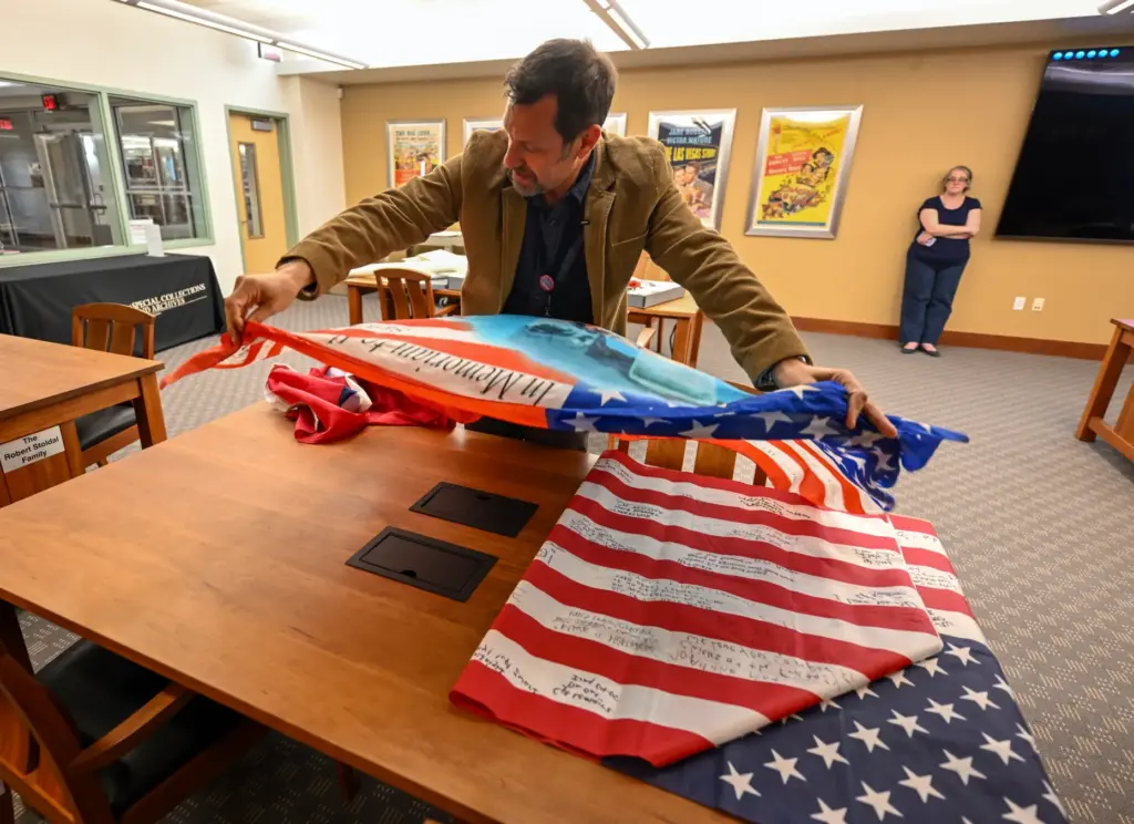 Professor David G. Schwartz looks over artifacts that were part...