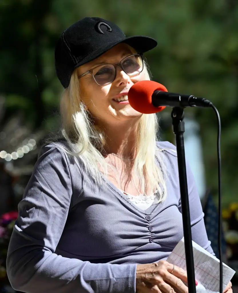 Cindy Totays, from Irvine, smiles as she speaks during a...