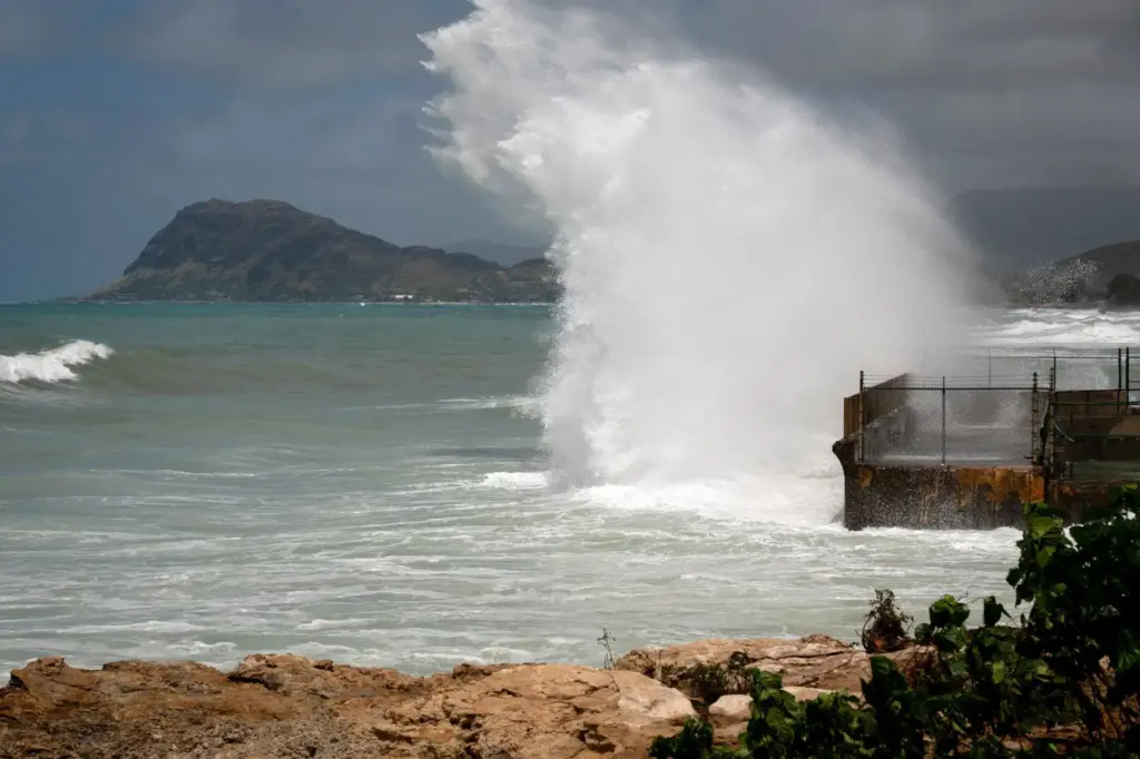 A large wave crashes on the shore caused by Hurricane Lowell.