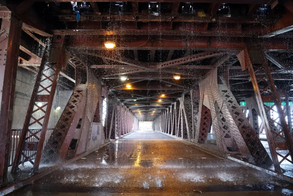 Water pumped by a Chicago Fire Department boat flows down...